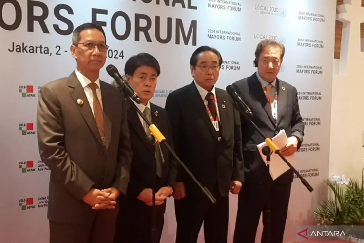 Acting Jakarta governor Heru Budi Hartono (left) stands with Toyota Mayor Toshihiko Ota (second left) at the 2024 International Mayors Forum (IMF) press conference in Jakarta on July 4, 2024.