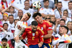 Germany's midfielder #08 Toni Kroos heads the ball past Spain's defender #02 Dani Carvajal and midfielder #08 Fabian Ruiz during the UEFA Euro 2024 quarter-final football match between Spain and Germany at the Stuttgart Arena in Stuttgart on July 5, 2024.