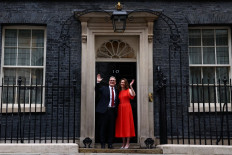 Britain's incoming Prime Minister and leader of the Labour Party, Keir Starmer, and his wife Victoria, wave as they pose on the steps of 10 Downing Street in London on July 5, 2024, a day after Britain held a general election. Starmer became Britain's new prime minister, as his center-left opposition Labour party swept to a landslide general election victory, ending 14 years of right-wing Conservative rule. 