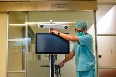 Orthopedist M. Satrio Nugroho Magetsari moves the supporting equipment for a robotic surgery on June 24, 2024, at Melinda 2 Hospital in Bandung, West Java.