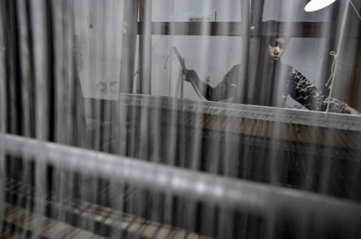 Thread of future: A weaver uses a loom on June 24, 2024 to produce traditional textiles at the Nusa eco-tourism village in Lhoknga, Aceh.