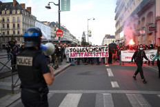 Supporters of the left wing coalition Nouveau Front Populaire (NFP) hold a banner reading “antifacist uprising“ after the first results of the second round of France's legislative election during an election night event in Rennes on July 7, 2024.