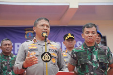 North Sumatra Police chief Comr. Gen. Agung Setya Effendi (left), accompanied by Bukit Barisan Military commander Lt. Gen. Mochammad Hasan (right), talks to reporters during a press briefing in Karo regency, North Sumatra on July 8, 2024.