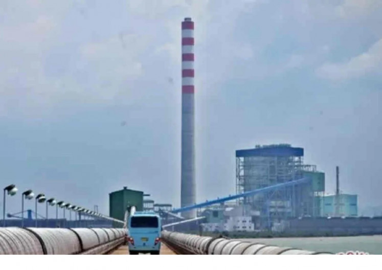 A bus travels near the Cirebon-1 coal-fired power plant in Cirebon, West Java, on Oct. 18, 2020.