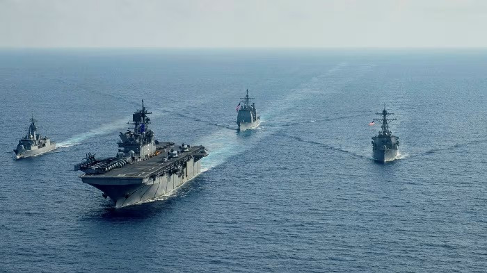 The Royal Australian Navy’s guided-missile frigate HMAS Parramatta (left) takes part in naval exercises in the South China Sea on April 18, 2020 with the United States Navy’s (from second left) supercarrier USS America, aircraft carrier USS Bunker Hill and guided-missile destroyer USS Barry.