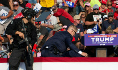 Secret Service agents surround United States Republican candidate Donald Trump as he is taken off the stage at a campaign event at Butler Farm Show Inc. in Butler, Pennsylvania, the US, on July 13, 2024. The suspected shooter who wounded Republican presidential candidate Donald Trump at a rally was shot dead at the scene, US media reported on Saturday.