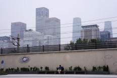 A person sits on a bench near Beijing's Central Business District (CBD) on July 14, 2024.