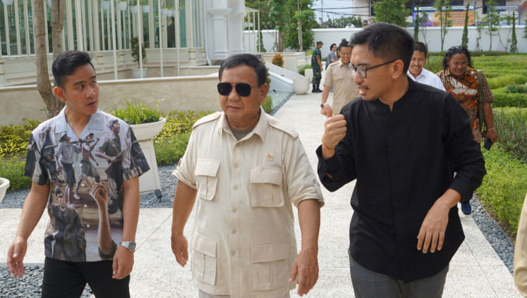 Surakarta King Mangkunegara X (right) walks on Jan. 24, 2023, alongside Surakarta Mayor Gibran Rakabuming Raka (left) and Defense Minister Prabowo Subianto (center) on the grounds of Mangkunegaran Palace in Surakarta, Central Java.