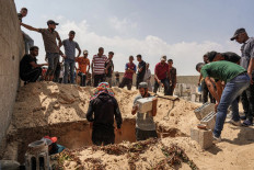 Palestinians bury the bodies of casualties of Israeli bombardment in Khan Yunis in the southern Gaza Strip on July 16, 2024 amid the ongoing conflict in the Palestinian territory between Israel and Hamas. 