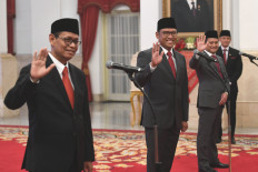 Newly appointed Deputy Finance Minister Thomas Djiwandono (center), nephew of Indonesia's Defense Minister and president-elect Prabowo Subianto, speaks on July 18, 2024, to the media after his inauguration at the Presidential Palace in Jakarta.
