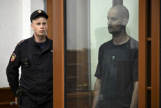 US journalist Evan Gershkovich, accused of espionage, stands inside a glass defendants' cage during the verdict announcement at the Sverdlovsk Regional Court in Yekaterinburg on July 19, 2024. 