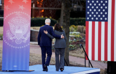 US President Joe Biden and Vice President Kamala Harris walk embraced on the grounds of Morehouse College and Clark Atlanta University in Atlanta, Georgia, US, January 11, 2022. 