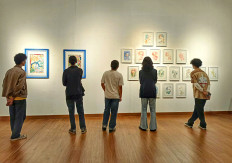 Still contemplation: Visitors look at paintings by Ayu Arista Murti on June 13, 2024 during the ‘Tiga Sisi: Jelajah dan Media' (Three sides: Explorations and media) exhibit at the National Gallery of Indonesia in Gambir, Central Jakarta.
