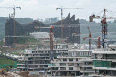 Scaffolding and cranes stand on July 11, 2024 at the site of the new presidential palace under construction in Nusantara, North Penajam Paser, East Kalimantan, slated for inauguration as the nation's new capital during the 79th Independence Day celebrations on Aug. 17, 2024. (AFP/Yasuyoshi Chiba)