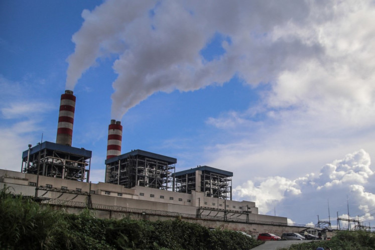 Chimneys belch emissions from a nickel smelter on July 7, 2024, at the Indonesia Weda Bay Industrial Park (IWIP) in Lelilef, North Maluku.