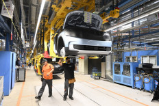 Employees work on the production line of the electric Ford Explorer at the Ford Electric Center Factory in Cologne, Germany, on June 4, 2024.