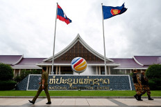 Security personnel walk on July 24, 2024, in front of the National Convention Centre, the venue for the ASEAN Foreign Ministers' Meeting and related meetings, in Vientiane, Laos.