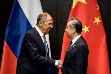 China's Foreign Minister Wang Yi (right) shakes hands with Russia's Foreign Minister Sergei Lavrov during a ministerial meeting on the sidelines of the 57th Association of southeast Asian Nations (ASEAN) Foreign Ministers' Meeting and Related Meetings in Vientiane on July 25, 2024.