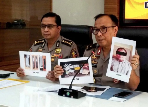 National Police spokespersons show on July 1, 2019, photographs of Jamaah Islamiyah (JI) terrorist group leader Para Wijayanto and various seized items at a press conference in Jakarta. The JI leader was arrested with his wife on at a hotel in Bekasi, West Java.