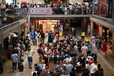 Passengers wait for their train departures at the Bordeaux-Saint-Jean train station in Bordeaux, western France on July 26, 2024, as France's high-speed rail network was hit by an attack disrupting the transport system, hours before the opening ceremony of the Paris 2024 Olympic Games. According to the French railway company SNCF, a massive attack on a large scale hit the high speed train network (TGV) on July 26, 2024, and many routes will have to be cancelled. The SNCF urged passengers to postpone their trips and stay away from train stations.