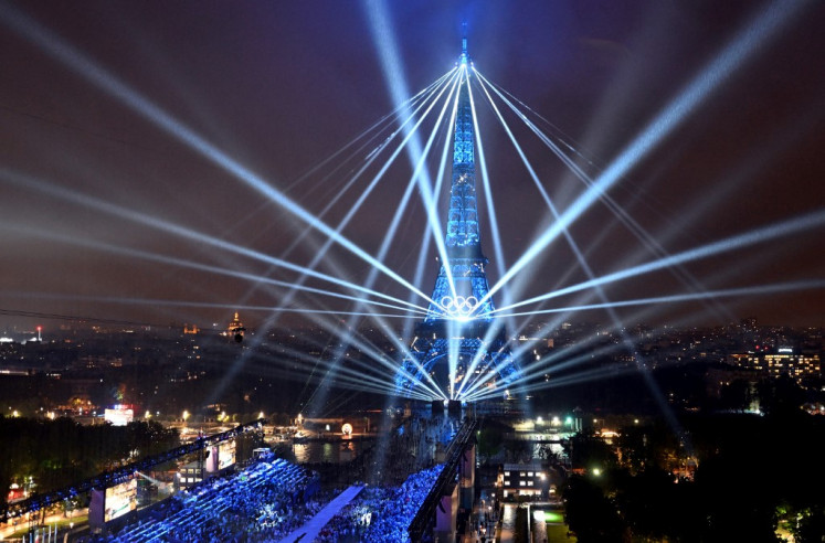 A general view of the Eiffel Tower and lasers lighting up the sky, during the opening ceremony of the Paris 2024 Olympic Games in Paris on July 26, 2024.