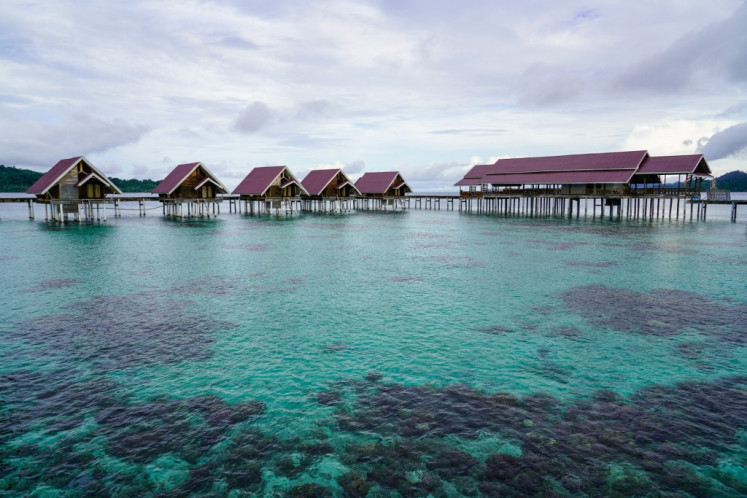 A general view of government-built overwater bungalows for tourists, that have been closed for renovation, next to the village of the Bajau sea nomads in Papan Island in Central Sulawesi on July 3, 2024. The Bajau tribe spread across Indonesia, the Philippines and Malaysia have spent centuries at sea, known for its members' lung-busting diving skills that allow them to fish underwater with their bare hands or spears for longer periods than other humans. But in Papan Island, a waterworld-like village in Central Sulawesi, residents say they have turned to new income streams as fish stocks fall, government pressure forces them to land and technology shifts their habits. 
