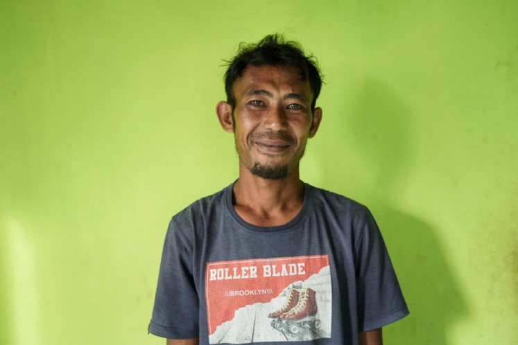 Fisherman Sofyan Sabi poses on July 3, 2024 at his home in the village of the Bajau sea nomads in Papan Island in Central Sulawesi. Sofyan Sabi's sea-dwelling community has fished beneath the waves off the Indonesian coast for centuries, but climate change and overfishing have forced him and many of his contemporaries on land to make a living.