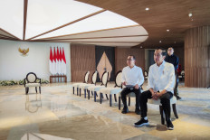 President Joko “Jokowi“ Widodo (front) sits alongside State Secretary Pratikno while inspecting a room at the Presidential Office in Nusantara on July 29, 2024, their first day of work in the country’s future capital in East Kalimantan.