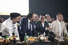 National Awakening Party (PKB) chair Muhaimin Iskandar (second right) talks with NasDem Party chair Surya Paloh (second right), Gerindra Party executive Sufmi Dasco Ahmad (right) and PKB deputy chair Jazilul Fawaid (left) during the PKB's 26th anniversary ceremony in Jakarta on July 23, 2024.