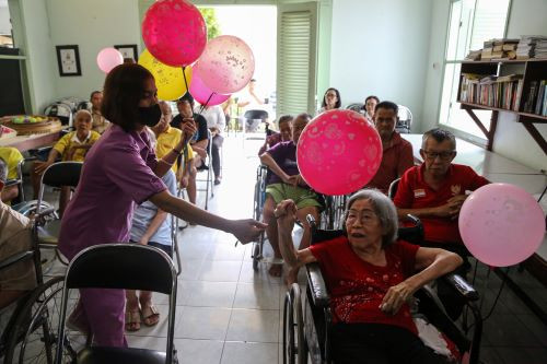 Senior moment: A caregiver gives an elderly woman a balloon at Pengayoman care home in Semarang, Central Java, on June 3 during the celebration of National Elderly Day.