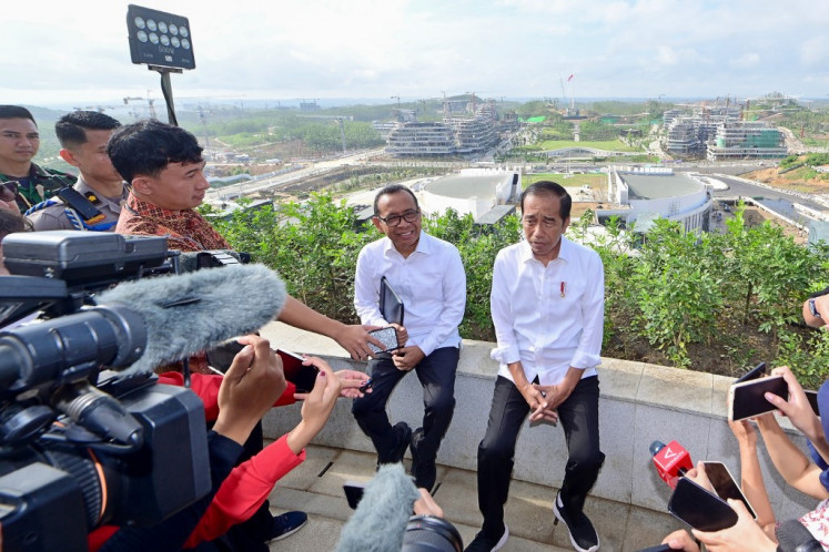 This handout picture taken and released on July 29, 2024, by the Presidential Palace shows President Joko “Jokowi“ Widodo (right) speaking to the media as he visits the new Presidential Palace in the Nusantara Capital City (IKN) in Penajam Paser Utara, East Kalimantan. 