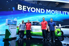 Pertamina president commissioner Simon Aloysius Mantiri (second left) and Pertamina senior vice president research & technology innovation Oki Muraza (second right) pose on July 26, 2024 alongside Toyota representatives in front of the Innova Zenix HEV Flex Fuel hybrid bioethanol car during the Gaikindo Indonesia International Auto Show (GIIAS 2024) at Indonesia Convention Exhibition in BSD City, Tangerang, Banten.