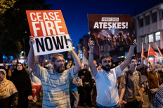 Pro-Palestinian demonstrators hold placards as they take part in a rally to protest the death of the Hamas leader Ismail Haniyeh, following evening prayers in Fatih district of Istanbul, Turkey on July 31, 2024. Hamas said on July 31 its political leader Ismail Haniyeh was killed in an Israeli strike in Iran, where he was attending the swearing-in of the new president, and vowed the act “will not go unanswered“.
