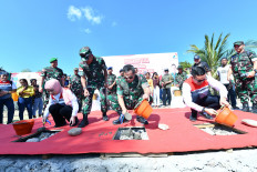 KUPANG &ndash; Indonesian Military (TNI) chief of staff Gen. Maruli Simanjuntak (center), Pertamina president director Nicke Widyawati (left) and Pertamina chief commissioner Simon Aloysius Mantiri (right), laid the first stone for the Construction of Livable Houses in Manusak Village, East Kupang, on Tuesday (30/7).