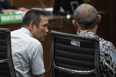 Former Bangka Belitung Islands energy and mineral resources agency heads Amir Syahbana (left) and Suranto Wibowo (right) sit in the defendants' chair at the Jakarta Corruption Court on July 31, 2024 during an indictment hearing pertaining to corruption in state-owned tin company PT Timah. Prosecutors charged the defendants, including a fellow former agency head Rusbani, of self-enrichment that caused Rp 300 trillion in state losses.