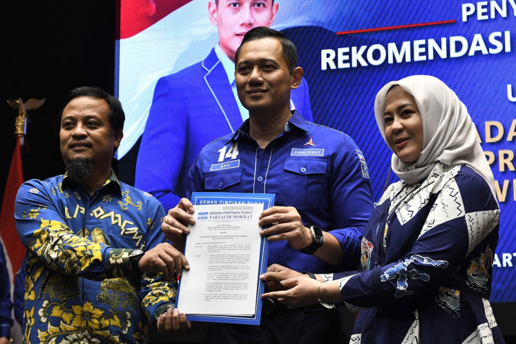 Democratic Party chairman Agus Harimurti Yudhoyono (center) hands over a recommendation to South Sulawesi gubernatorial hopeful Andi Sudirman Sulaiman (left) and his potential running mate Fatmawati Rusdi (right) to run in the upcoming provincial head election at the party's headquarters in Jakarta on July 19, 2024.