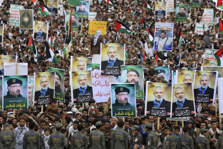 Yemenis wave flags and lift placards of Hezbollah senior commander Fuad Shukr, who was killed in an Israeli strike, and slain Hamas chief Ismail Haniyeh, during a rally in the Huthi-controlled capital Sanaa on Aug. 2, 2024, denouncing their killing, amid the ongoing conflict in the Gaza Strip between Israel and the Palestinian Hamas movement. Haniyeh, the Palestinian armed group's political chief, who was killed on July 31 in the Iranian capital Tehran, played a key role in mediated talks aimed at ending nearly 10 months of war between Hamas and Israel in Gaza.