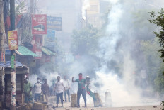 Police use tear gas to disperse student protestors in Bogura on August 4, 2024. 