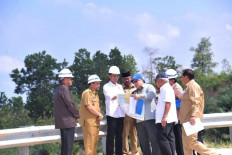President Joko “Jokowi” Widodo (third left), along with other officials, looks at a map as he visits Bukit Soeharto in Kutai Kartanegara regency, East Kalimantan on May 7. Bukit Soeharto, was one of several areas that had been nominated for the site of a new capital city. 