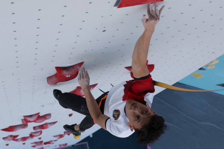 An overview shows Indonesian Veddriq Leonardo taking part in the preliminary round of men's speed climbing during the 2024 Olympic Games in Paris on August 6, 2024 at the Le Bourget sport climbing stadium in Le Bourget.