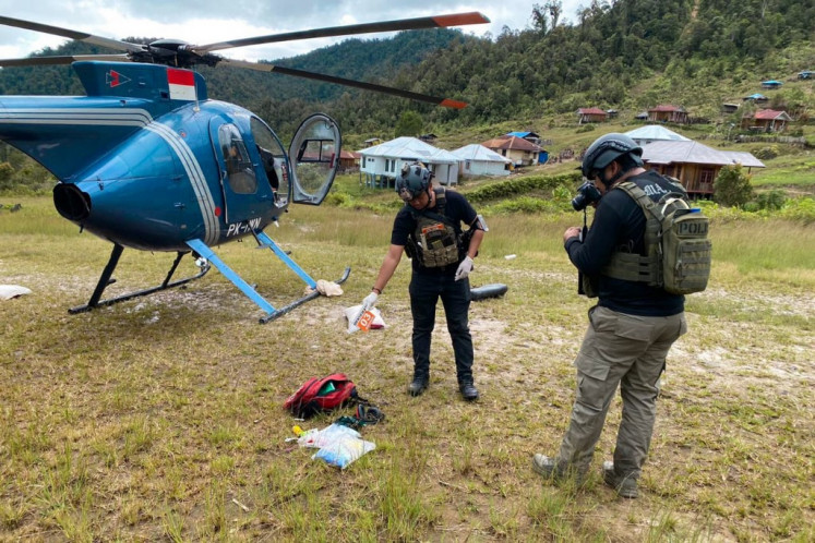 This handout photograph taken and released by the Cartenz Peace Taskforce on Aug. 6, 2024, shows members of a joint task force of police leading an investigation at the site where a New Zealand helicopter pilot was shot dead by rebels the day before, in Mimika Regency, Central Papua. Glen Malcolm Conning, 50, a pilot for PT Intan Angkasa Air Service, was killed on Aug. 5, after landing in Papua with four Indonesian health workers and two children, all of whom survived.
