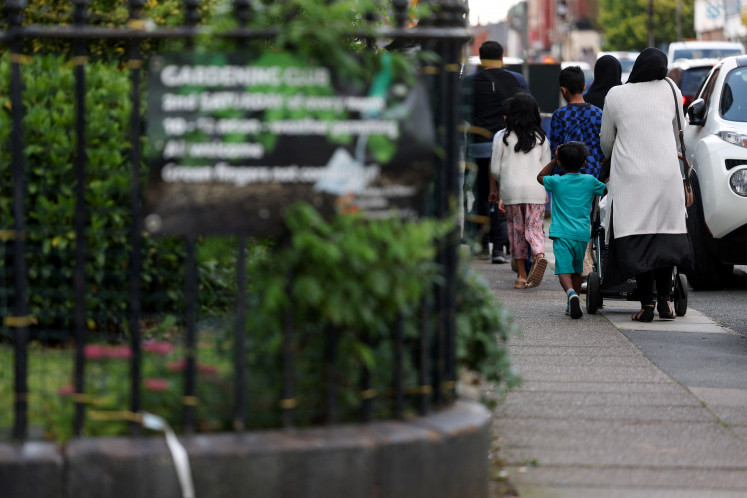 A muslim family walks in a street, amid rioting across the country in which mosques and Muslims have been targets, in Liverpool, Britain August 6, 2024.
