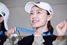 South Korean pistol shooter Kim Ye-ji, whose video of breaking a world record at the Olympics with almost no visible reaction went viral on social media, shows her silver medal to the press at the Incheon International Airport in Incheon, South Korea, on Aug. 7, 2024.