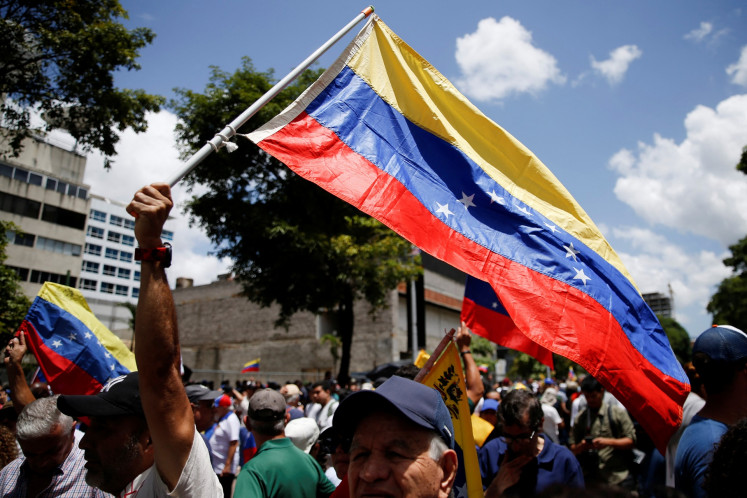 Demonstrators wave flags as they gather to protest against election results that awarded Venezuela's President Nicolas Maduro with a third term, in Caracas, Venezuela, on Aug. 3, 2024.
