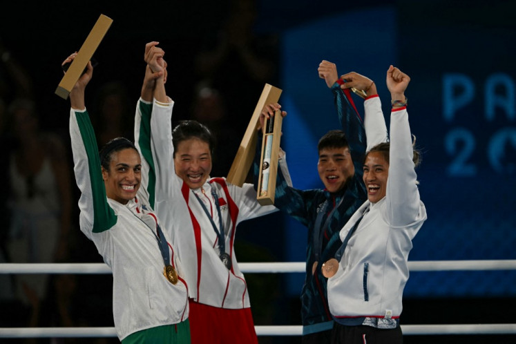(From left to right) Gold medalist Algeria's Imane Khelif, Silver medalist China's Yang Liu, and bronze medalists Thailand's Janjaem Suwannapheng and Taiwan's Chen Nien-chin pose on the podium during the medal ceremony for the women's 66-kilogram final boxing category during the 2024 Olympic Games in Paris at the Roland-Garros Stadium, in Paris on Aug. 9, 2024.
