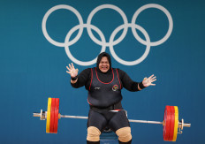 Nurul Akmal of Indonesia reacts after failing a lift during the women's +81-kilogram weightlifting event at the 2024 Summer Olympic Games in Paris on Aug. 11, 2024.