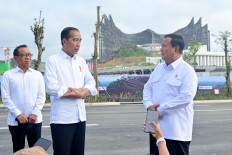 President-elect Prabowo Subianto (right) and President Joko “Jokowi“ Widodo (center) stand before the press in front of the freshly finished Garuda Palace in the future capital Nusantara on Aug. 12, 2024.