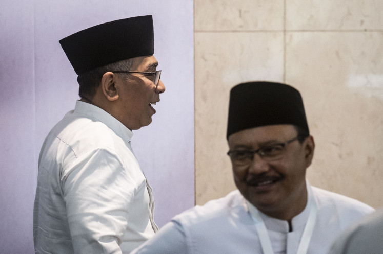 Nahdlatul Ulama (NU) chairman Yahya Cholil Staquf (left) and secretary-general Saifullah Yusuf (right) leaves the room on July 28, 2024, after a press briefing on the result of the organization's central board plenary meeting in Jakarta.