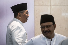 Nahdlatul Ulama (NU) chairman Yahya Cholil Staquf (left) and secretary-general Saifullah Yusuf (right) leaves the room on July 28, 2024, after a press briefing on the result of the organization's central board plenary meeting in Jakarta.