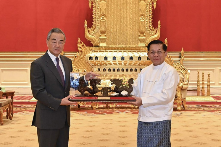 This photograph taken and released on August 14, 2024 by the Myanmar Military Information Team shows Myanmar's military chief Min Aung Hlaing (right) meeting with China's Foreign Minister Wang Yi in Naypyidaw. 